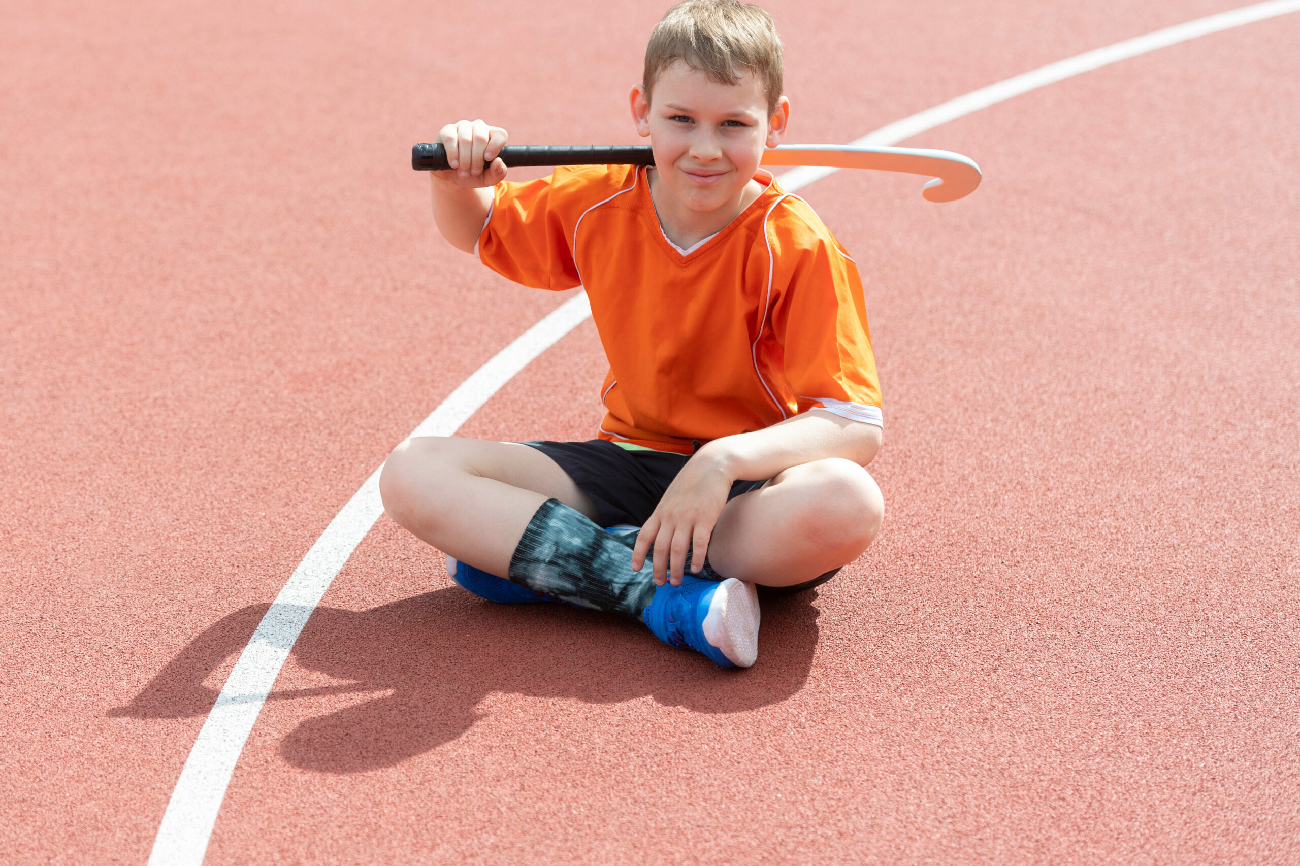 boy playing field hockey with stick. concept of a sports lifestyle, training, camp, leisure, vacation. horizontal sport theme poster, greeting cards, headers, website and app